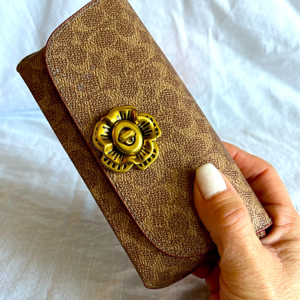 Coach glasses case with a beautiful and classy floral clasp.